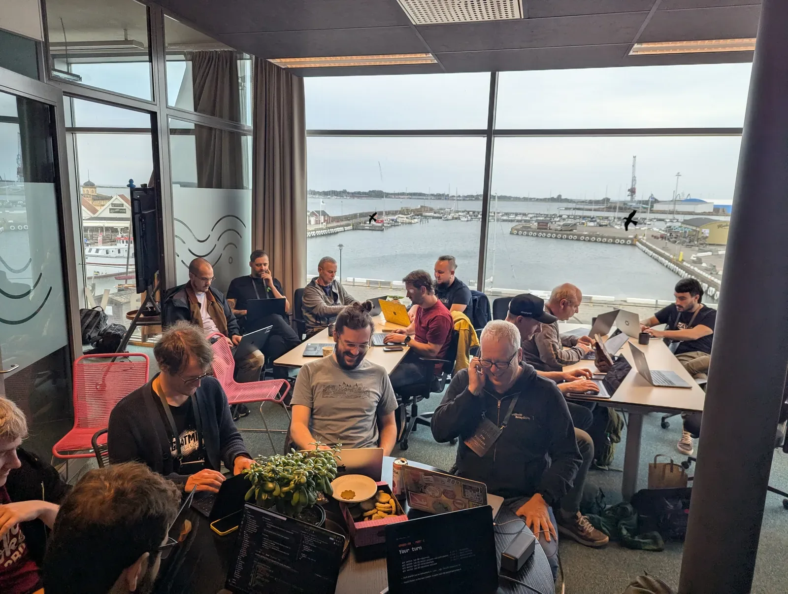 Attendees working through the labs at tables overlooking Varberg harbour